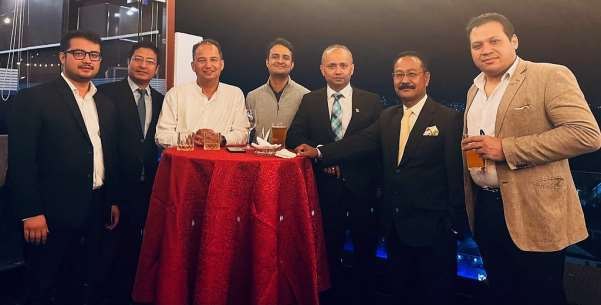 Group of guests around a table at the Dashain and Tihar celebration